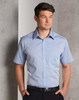 A light blue short sleeve button-up shirt with a single chest pocket and a branding logo.