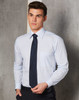 A light blue long sleeve button-up shirt featuring a single chest pocket and paired with a dark tie.