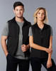 A unisex reversible vest in black, featuring two models wearing it over grey t-shirts. The vest has a zip fastening and a logo.