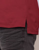 A close-up of a burgundy long sleeve polo shirt, featuring side slits for ease of movement.