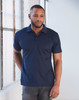 A man models a navy blue short-sleeved polo shirt, featuring a collar and a logo on the chest.