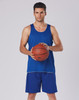 A model in blue basketball shorts and a matching tank top holds a basketball. The outfit has a logo present.