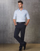 Men’s permanent press slacks in navy blue, paired with a light blue shirt and black belt, standing against a textured background.