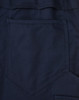 A close-up of navy pants featuring a segmented design and a rear pocket. The fabric has a ripstop texture.