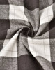 A close-up of grey and white flannel fabric with a plaid pattern, showing the texture and weave.