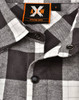 A black and white plaid unisex flannel button-up shirt featuring a collar and branded tag.
