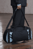 A black duffle bag with light blue accents, featuring multiple zippered pockets and a shoulder strap.