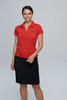 A model wearing a red polo shirt and black skirt, featuring a logo on the polo.