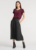 A maroon short sleeve blouse paired with a black skirt. The outfit features a keyhole neckline and side pockets.