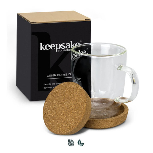 A transparent glass coffee mug with a cork coaster, presented in a black box.