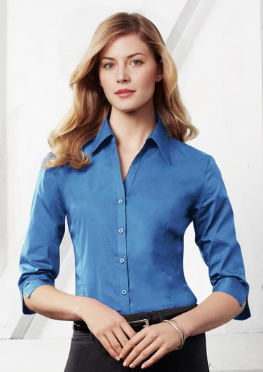 A women's button-up shirt in a vibrant blue colour with 3/4 sleeves and a fitted style, featuring a logo.