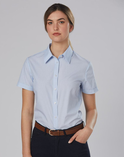 A light blue women's button-up shirt with short sleeves, featuring a collar and a logo.