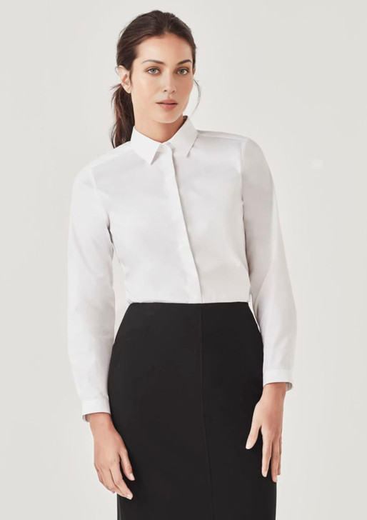 A white long sleeve button-up shirt displayed on a model, paired with a black skirt. The shirt has a collar and features a logo.