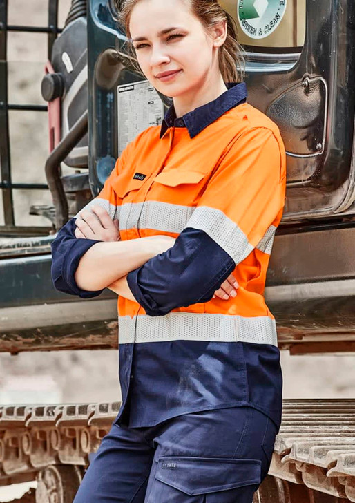 A long sleeve women's work shirt in high visibility orange and navy, featuring reflective tape and a logo.