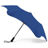 A blue BLUNT Metro Umbrella with an ergonomic handle and a sleek design, featuring a brand logo.