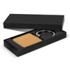 A square wooden key ring in a black gift box, featuring a metallic keyring attachment.