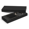 A square black key ring with a textured surface, presented in a sleek black gift box.