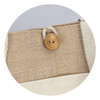 A tan jute tote bag featuring a natural wooden button and cream straps. It has a simple, eco-friendly design.