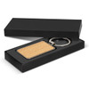 A rectangular key ring with a wooden surface, presented in a black gift box.