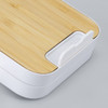 A wireless charging stand with a bamboo top and a white base, featuring a small slot for device placement.
