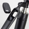 A black selfie stick tripod with a remote control attached, featuring a shiny metallic section and a sleek design.