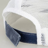 A faded navy trucker cap with a white mesh back and a dark fabric strap at the rear.