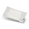 A small, white, compressed towel packaged in a clear wrapper with a logo.