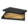 A wooden cheese board with a handle, presented in a black gift box, features two circular cutouts and a matching knife.
