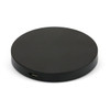 A round black wireless charger with a USB-C port visible on the side. It features a simple and sleek design.