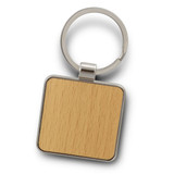 A square key ring featuring a wooden surface and a silver metal keychain attachment.