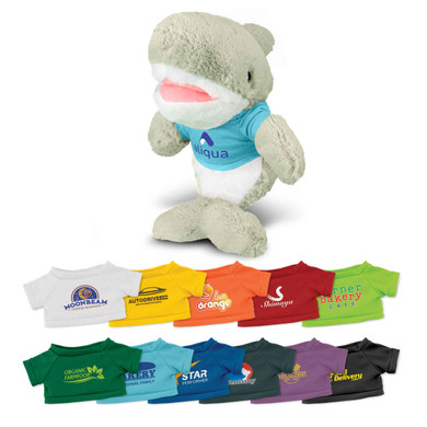 A plush shark toy in grey with a blue top, standing alongside a variety of colourful miniature t-shirts.