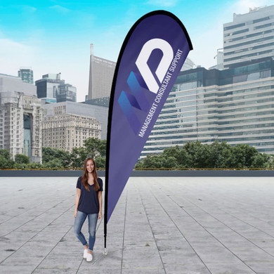 A large teardrop flag kit in blue, featuring a logo, displayed outdoors with a city skyline in the background.