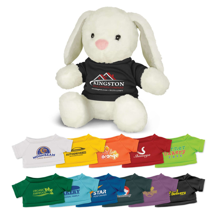 A plush white rabbit toy wearing a black T-shirt, surrounded by colourful miniature T-shirts in various shades.