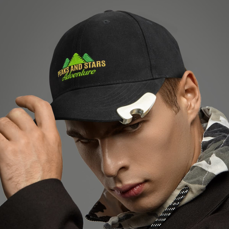 A drink bottle opener cap in black with a silver opener attachment, featuring a logo with green trees on the front.