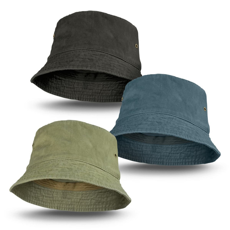 A collection of three faded bucket hats in olive green, blue-grey, and dark green, featuring brass eyelets.