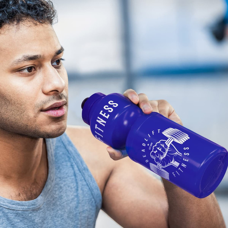 A drink bottle in vibrant purple with a logo, held by a person during a workout.