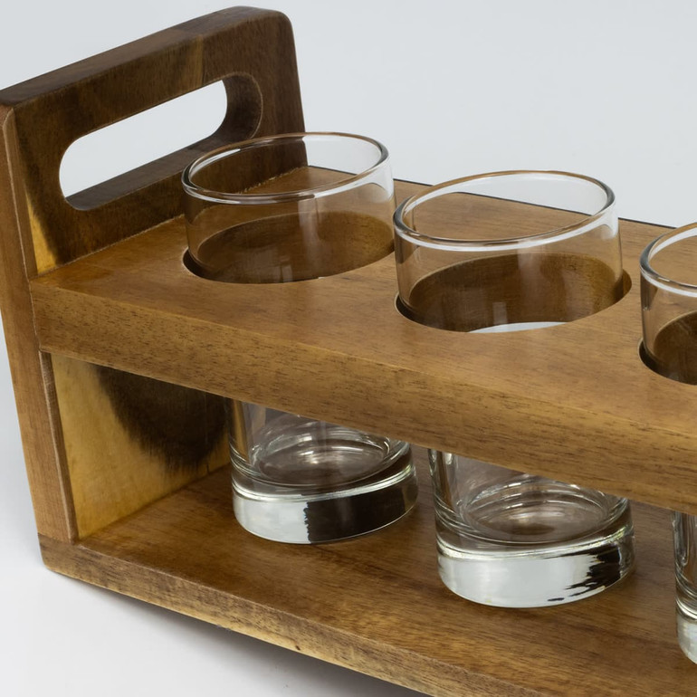 A wooden tray with a handle holds three clear glass tumblers, showcasing a rich brown colour.