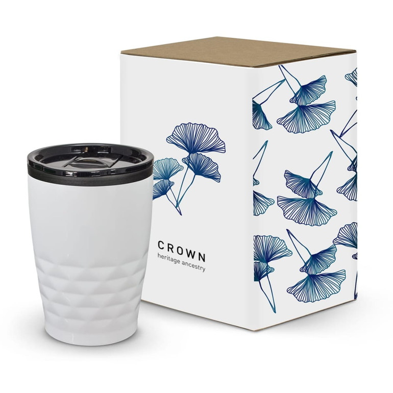 A white coffee cup with a patterned surface, accompanied by a decorative box featuring floral designs.