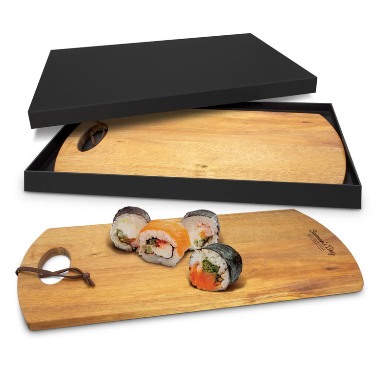 A wooden serving board in a black box, featuring a unique shape and sushi displayed on top.