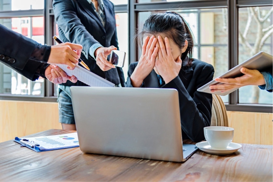 Busy person frustrated by workplace demands for promotional branded merchandise.