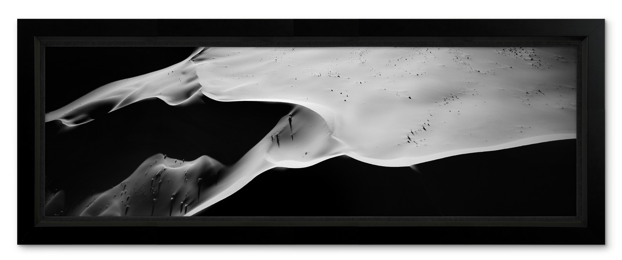 Aerial black and white photo of Namibia’s Skeleton Coast showing artistic sand dunes sculpted by wind and light.