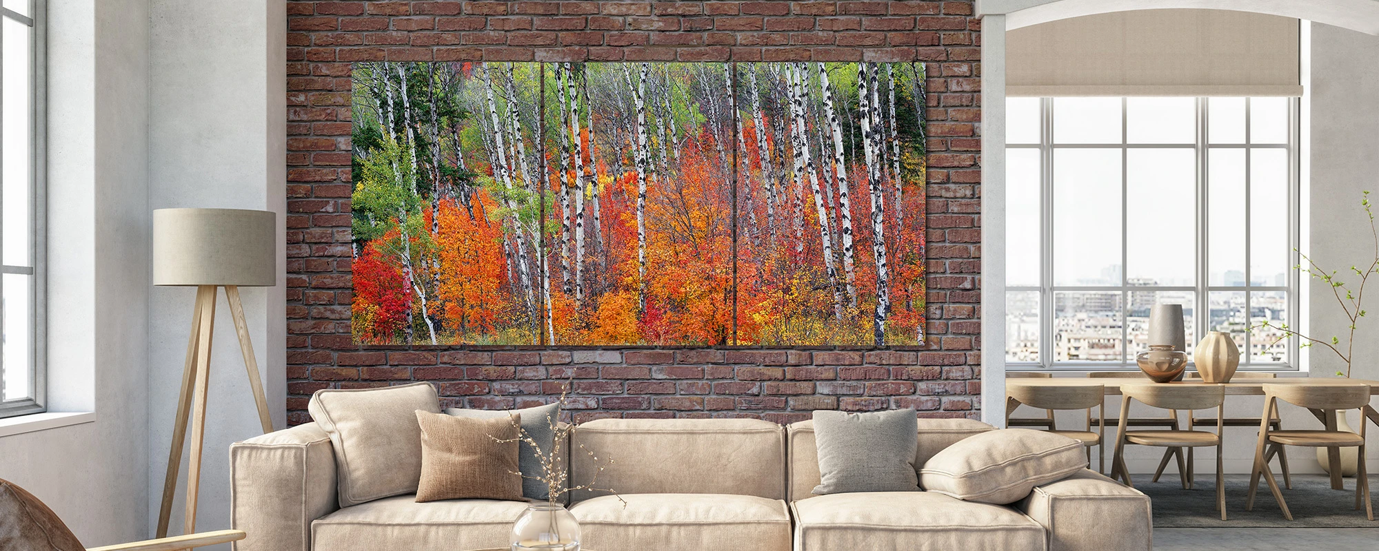 Mangelsen's large multi-panel photograph of fall color & white aspens hung over a sofa.