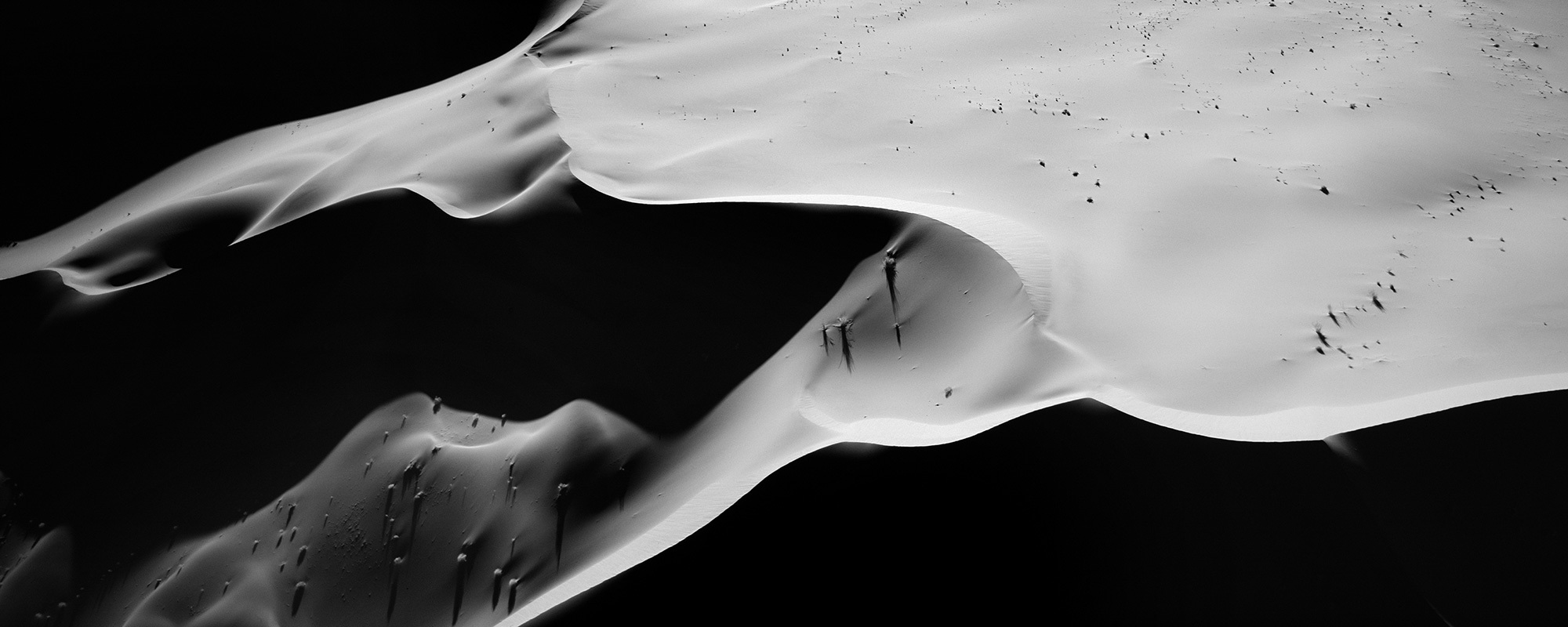 Giant sand dunes sculpted with light and shadow in Namibia
