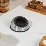 Stainless steel kitchen timer with black dial on countertop