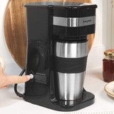 Black Salter filter coffee machine with stainless steel travel mug, power button pressed
