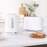 White textured kettle and toaster set on kitchen counter with sliced bread