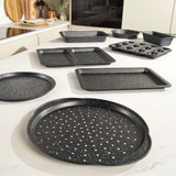 Set of non-stick black speckled baking trays and tins on kitchen worktop