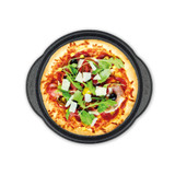 Homemade pizza with rocket, parmesan, olives and cured meats in a black baking tray