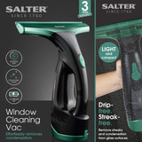 Cordless Salter window cleaning vac in black and green, shown removing condensation from glass.