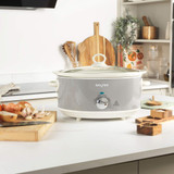 Grey Salter slow cooker with white handles and dial, cooking settings visible, lid to the side